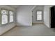 Bright bedroom with neutral carpet, lots of windows, and trim detail at 7160 Round Rd, Cumming, GA 30040