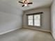 Serene bedroom with neutral carpet, ceiling fan, and natural light from the window at 7160 Round Rd, Cumming, GA 30040