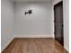 Bedroom with hardwood floors, dark door, and wall mount at 7160 Round Rd, Cumming, GA 30040