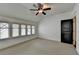 Cozy bedroom with natural light, ceiling fan, and modern grey decor at 7160 Round Rd, Cumming, GA 30040