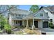 Charming home featuring stone accents, a covered front porch, and an attached two-car garage at 7160 Round Rd, Cumming, GA 30040