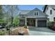 Stunning exterior view featuring gray siding, stylish windows, and a covered garage entrance at 7160 Round Rd, Cumming, GA 30040