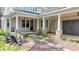 Inviting front porch with stone pathway, stylish columns, and an outdoor seating area at 7160 Round Rd, Cumming, GA 30040