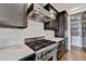 This kitchen features stainless steel appliances, white marble countertops, and dark wood cabinets at 7160 Round Rd, Cumming, GA 30040