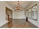 Bright living room with hardwood floors, stylish lighting, and adjacent staircase at 7160 Round Rd, Cumming, GA 30040
