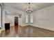 Spacious living room featuring hardwood floors, decorative trim, and a stylish chandelier at 7160 Round Rd, Cumming, GA 30040
