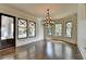 Spacious living room with hardwood floors, decorative lighting, and views from the window at 7160 Round Rd, Cumming, GA 30040