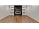 Contemporary living room featuring a fireplace, built-in shelving and hardwood floors at 7160 Round Rd, Cumming, GA 30040