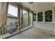 Covered porch with wood floors, white railing and elegant curtains at 7160 Round Rd, Cumming, GA 30040