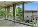 Covered porch with wood floors, white railing and elegant curtains at 7160 Round Rd, Cumming, GA 30040