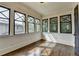 This sunroom features multiple windows, and hardwood flooring at 7160 Round Rd, Cumming, GA 30040
