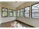 Sunroom with hardwood floors and many windows at 7160 Round Rd, Cumming, GA 30040