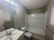 Clean bathroom with tile flooring, tub and shower combo, and modern fixtures at 883 Greenhedge Dr, Stone Mountain, GA 30088