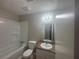 Bathroom featuring a tub with shower, a toilet, and a vanity with a sink at 883 Greenhedge Dr, Stone Mountain, GA 30088