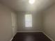 Neutral bedroom featuring a ceiling fan, window with blinds, and dark wood floors at 883 Greenhedge Dr, Stone Mountain, GA 30088