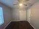 Simple bedroom with wood floors, double door closet, and neutral paint at 883 Greenhedge Dr, Stone Mountain, GA 30088