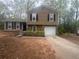 Charming two-story home with a well-manicured lawn and a welcoming front entrance at 883 Greenhedge Dr, Stone Mountain, GA 30088