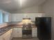 Functional kitchen with stainless steel appliances, light colored cabinets, and ample counter space at 883 Greenhedge Dr, Stone Mountain, GA 30088