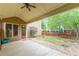 View of back patio with covering, partial fence, and tree at 9912 Mancunian Way, Douglasville, GA 30135