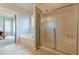 Bright bathroom featuring a shower, a tub, and tile floors connecting it to an adjacent bedroom at 9912 Mancunian Way, Douglasville, GA 30135