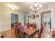 Formal dining room with elegant chandelier and adjacent spaces at 9912 Mancunian Way, Douglasville, GA 30135