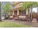 Inviting covered front porch with brick accents and pretty landscaping at 9912 Mancunian Way, Douglasville, GA 30135