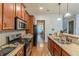 Well-equipped kitchen with stainless steel appliances, granite counters and hardwood floors at 9912 Mancunian Way, Douglasville, GA 30135
