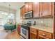 Kitchen featuring stainless steel appliances, granite countertops and hardwood floors at 9912 Mancunian Way, Douglasville, GA 30135