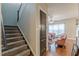 Carpeted staircase leading to the second floor and nearby living room at 9912 Mancunian Way, Douglasville, GA 30135
