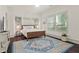 Light-filled bedroom with a hardwood floor, multiple windows, and an accent rug at 1200 Virginia Ct # 101, Atlanta, GA 30306