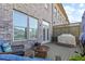 Outdoor deck area featuring brick siding, cozy seating, and a privacy fence at 1200 Virginia Ct # 101, Atlanta, GA 30306