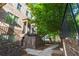 Stylish brick townhome featuring steps leading to the front entrance and a lush green tree at 1200 Virginia Ct # 101, Atlanta, GA 30306