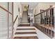 Inviting foyer featuring hardwood floors, a staircase with iron railings, and stylish décor, creating an elegant entrance at 1200 Virginia Ct # 101, Atlanta, GA 30306