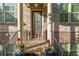 Charming brick home featuring a welcoming front porch with columns, potted plants, and a stately front door at 1200 Virginia Ct # 101, Atlanta, GA 30306