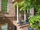 Brick front porch with iron railings, columns, and planters, creating an inviting entrance to the brick home at 1200 Virginia Ct # 101, Atlanta, GA 30306