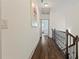 Hallway with hardwood floors, neutral walls, railing and artwork, leads to various rooms in the home at 1200 Virginia Ct # 101, Atlanta, GA 30306