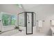 Bathroom featuring glass shower, large garden tub, and view of the wooded outdoors at 1228 Dunwoody Walk, Atlanta, GA 30338
