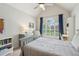 Inviting bedroom with vaulted ceiling and large window, bathed in soft natural light at 1228 Dunwoody Walk, Atlanta, GA 30338