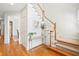 Bright foyer with hardwood floors, staircase, console table, and neutral decor at 1228 Dunwoody Walk, Atlanta, GA 30338