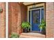 Elegant blue front door with glass detailing, potted plants, and brick accents at 1228 Dunwoody Walk, Atlanta, GA 30338