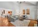 Bright and airy living room with an open floor plan, fireplace, and views into the kitchen at 1228 Dunwoody Walk, Atlanta, GA 30338