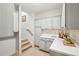 Pantry area featuring white cabinetry, countertop, backsplash, and staircase leading to another level of the home at 1228 Dunwoody Walk, Atlanta, GA 30338