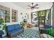 Relaxing screened porch with wicker furniture, leafy plants, ceiling fan, and scenic views of the lush outdoors at 1228 Dunwoody Walk, Atlanta, GA 30338