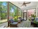 Inviting sunroom with comfortable seating, ceiling fan, and views of the lush backyard at 1228 Dunwoody Walk, Atlanta, GA 30338