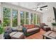 Bright sunroom with multiple windows, comfortable seating, and ceiling fan offering a relaxing space to enjoy the view at 1228 Dunwoody Walk, Atlanta, GA 30338