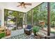 Relaxing sunroom featuring comfortable seating and scenic views of the backyard at 1228 Dunwoody Walk, Atlanta, GA 30338