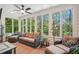 Cozy sunroom with walls of windows, comfortable seating, and natural light at 1228 Dunwoody Walk, Atlanta, GA 30338