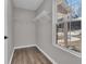 Walk-in closet features a window, wire shelving, and wood floors at 217 Lamb Rd, Moreland, GA 30259