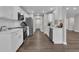 Open kitchen with stainless appliances, sleek countertops, and updated white cabinets at 217 Lamb Rd, Moreland, GA 30259