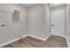 A utility room with wood-look floors, white trim, and a wire rack at 217 Lamb Rd, Moreland, GA 30259